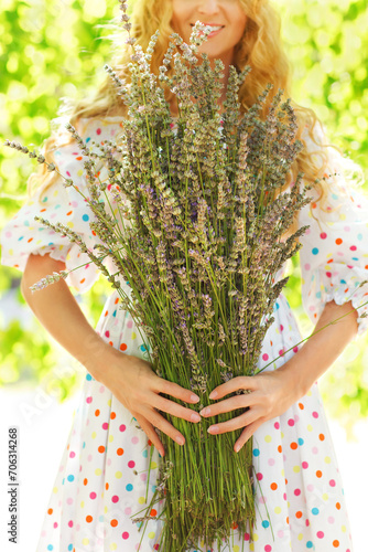 Romantic woman with long blond hair with lavender bouquet
