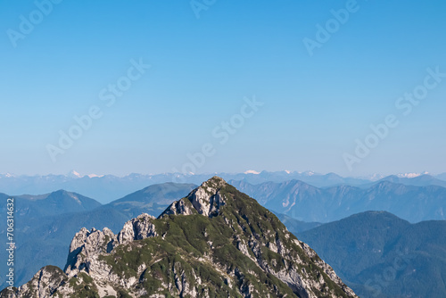 Mountain summit of Monte Traunig in wild Julian Alps near Tarvisio, Friuli Venezia Giulia, Italy. Panoramic view of Gailtal Alps and Karwanks in Carinthia, Austria. Wanderlust alpine terrain in summer