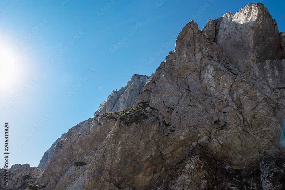 Scenic via ferrata hiking trail to mount Mangart (Mangrt), Julian Alps, Friuli Venezia Giulia, Italy, Europe. Climbing through treacherous rugged mountainscape amidst extreme alpine terrain in summer
