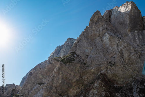 Scenic via ferrata hiking trail to mount Mangart (Mangrt), Julian Alps, Friuli Venezia Giulia, Italy, Europe. Climbing through treacherous rugged mountainscape amidst extreme alpine terrain in summer