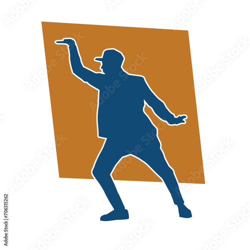 Silhouette of a slim male in dance pose. Silhouette of a man dancing. photo