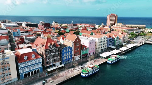 The drone is flying away from the old colorfull houses on the trade quay (handelskade) in Willemstad Curacao Aerial Footage 4K photo