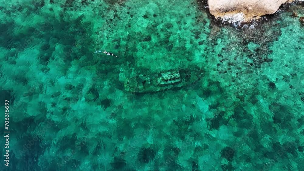 The drone is flying around a shipwreck in the ocean where people are snorkeling in Curacao Aerial Footage 4K The drone is flying around a shipwreck in the ocean where people are snorkeling in Curacao Aerial Footage 4K