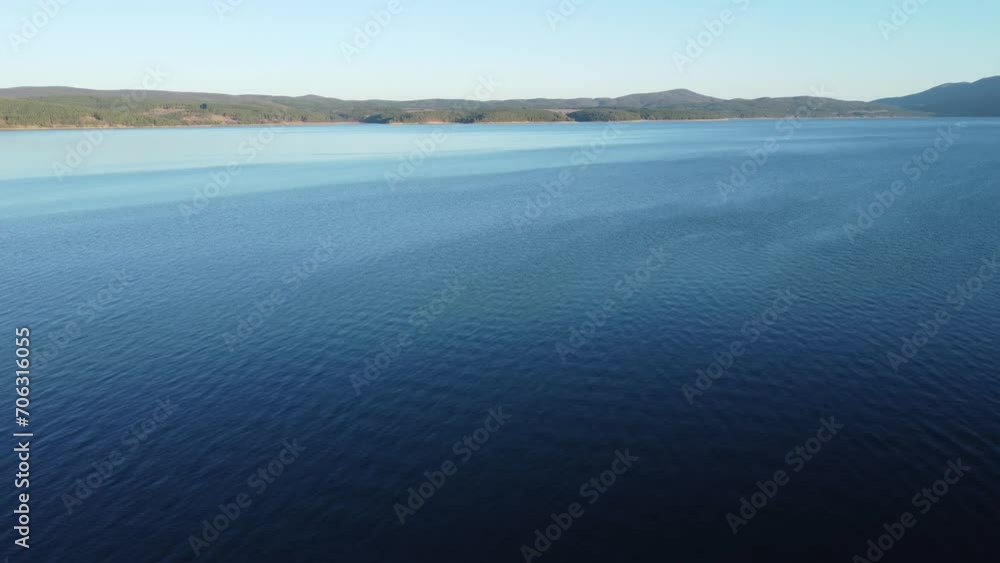 Static aerial clip of rippes on the serene Iskar reservoir near Sofia, Bulgaria towards the Balkans in the background Static aerial clip of rippes on the serene Iskar reservoir near Sofia, Bulgaria towards the Balkans in the background
