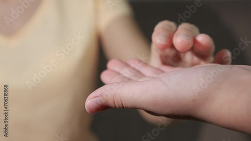 Give a help hands for mum. A view of woman hand in girl's hand indoor. A concept of family love and support. photo