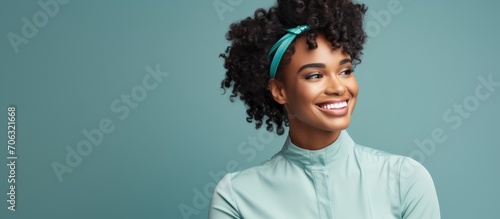 Smiling vaccinated millennial black woman with medical band on shoulder, isolated. photo
