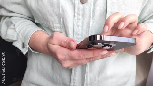 a young woman whines a tape on social networks on a smartphone close-up