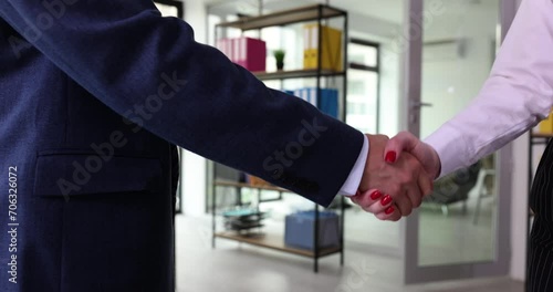 Male hands and shake successful corporate partnership deal with woman. Business people shaking hands in office and congratulations on signing contract documents photo
