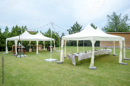 Large folding white tents at a wedding party. Place for wedding banquet outdoor