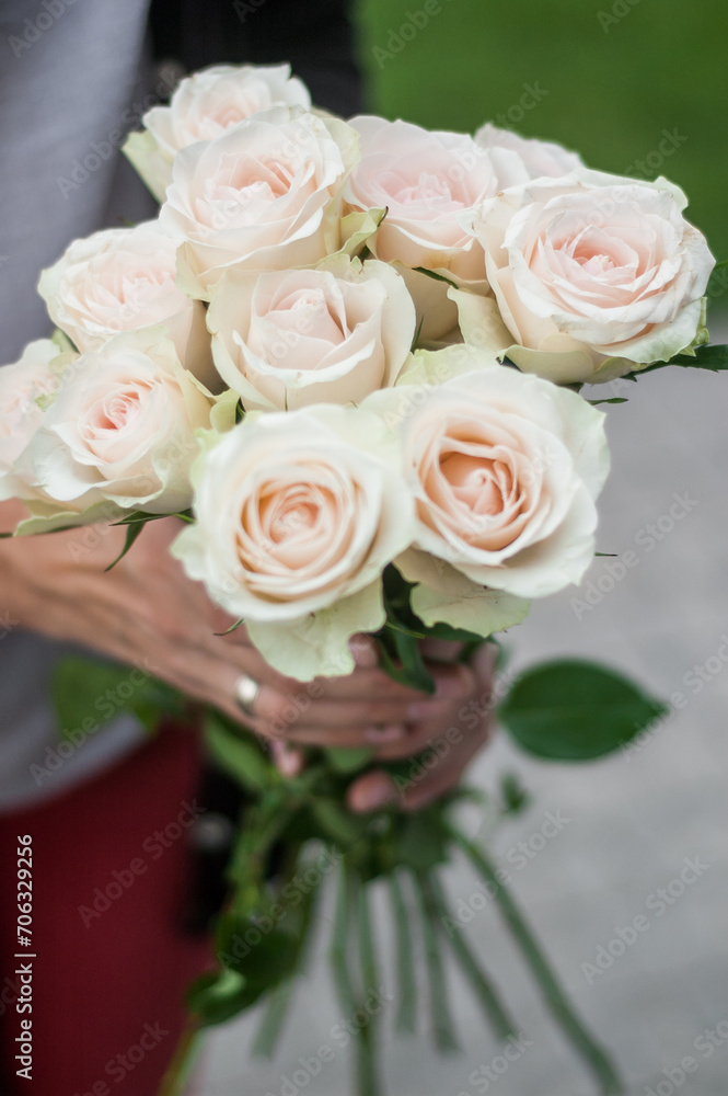Bouquet of white roses in female hands