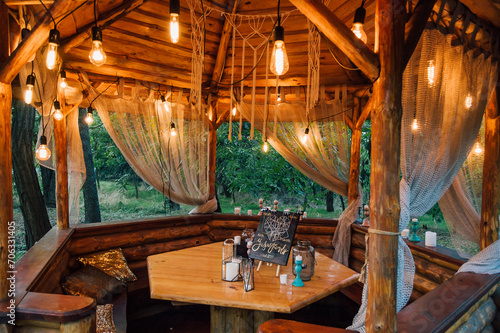 Gazebo with bulbs in late evening. Romantic scene in dusk.
