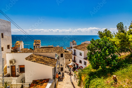 urban narrow street in the Spanish city of Altea on a summer day photo
