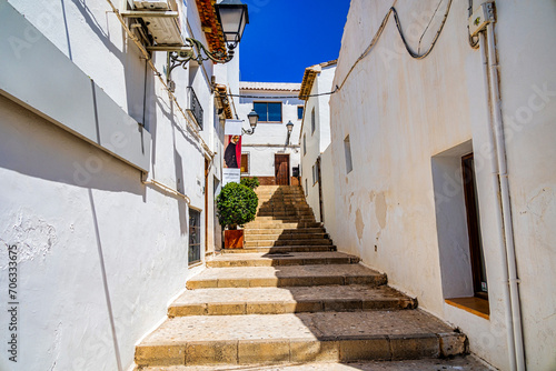 urban narrow street in the Spanish city of Altea on a summer day © Joanna Redesiuk