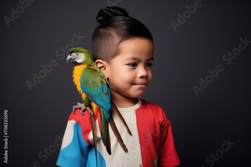 child with a parrot on their shoulder
