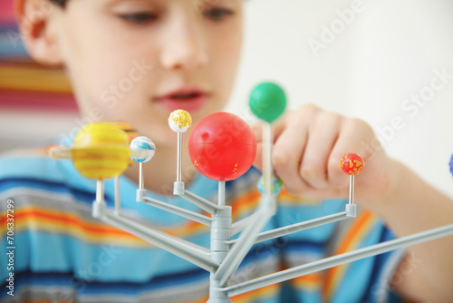 Boy Inspecting Solar System Model

