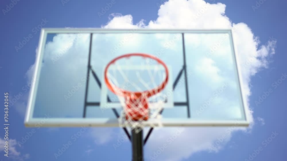 Big white clue sky cloud against unfocused playground basketball hoop