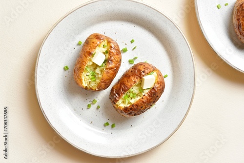 Baked filled potatoes with butter and green onion
