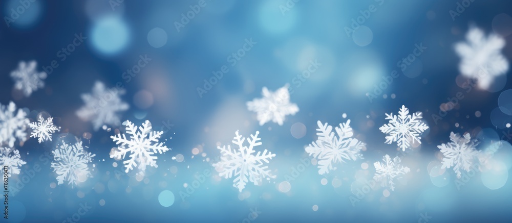 Blue background with bokeh in the shape of snowflakes.