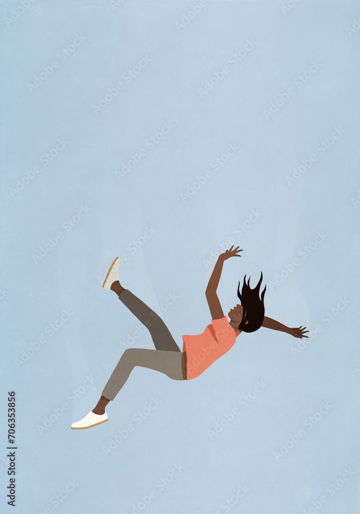 Woman falling midair against blue sky
Woman falling midair against blue sky