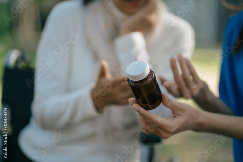 female therapist gives medication advice to an elderly patient.