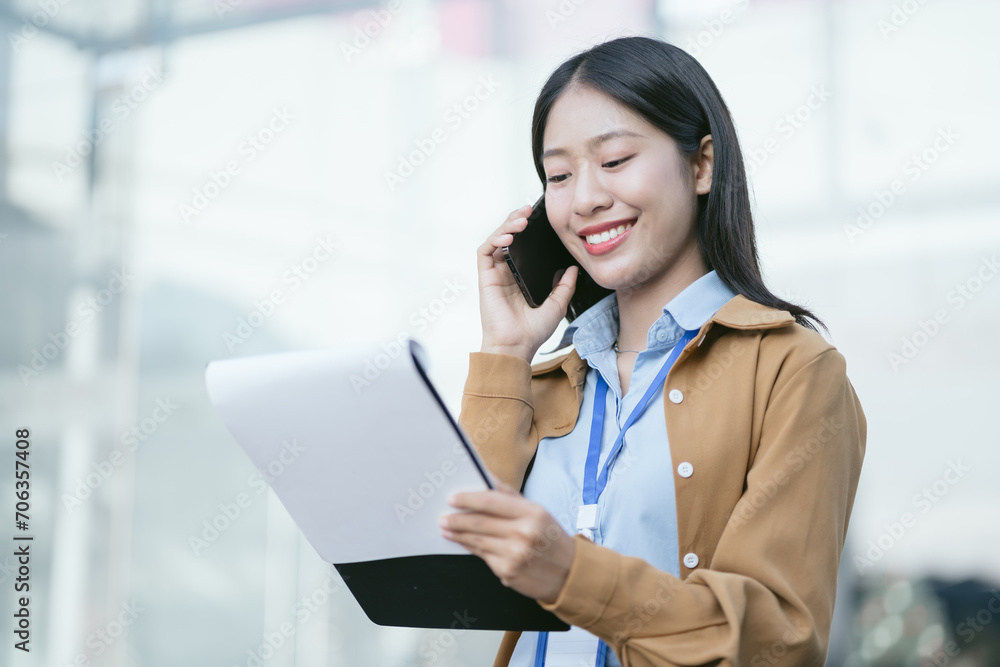 Businesswoman walking and talking phones on street in city Outside Office Businesswoman walking and talking phones on street in city Outside Office
