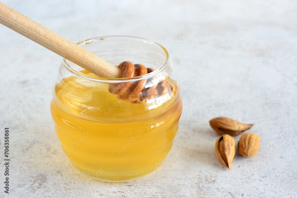 honey in jar with wooden honey dipper close up honey in jar with wooden honey dipper close up
