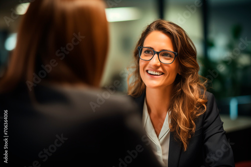 Smiling professional in a business meeting, conveying confidence and leadership in an office setting.