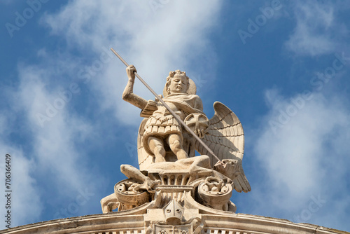 Statue of St Michael killing the Satan , on the top of St Jacobs cathedral in Sibenik, Croatia, low angle view