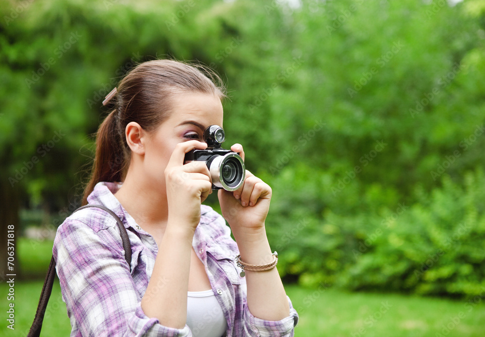 Beautiful smiling young girl with camera Beautiful smiling young girl with camera