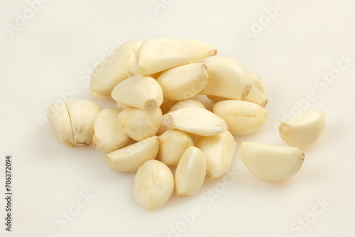 bawang putih kupas or peeled garlic on white background photo
