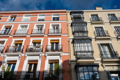 Colorful facades of apartment buildings in the Opera neighborhood in the center of Madrid in Spain photo