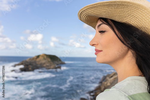 close up portrait of woman in profile with hat looking at the horizon on vacation looking for inspiration