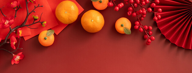 Chinese lunar new year background with fresh tangerine and red envelope.