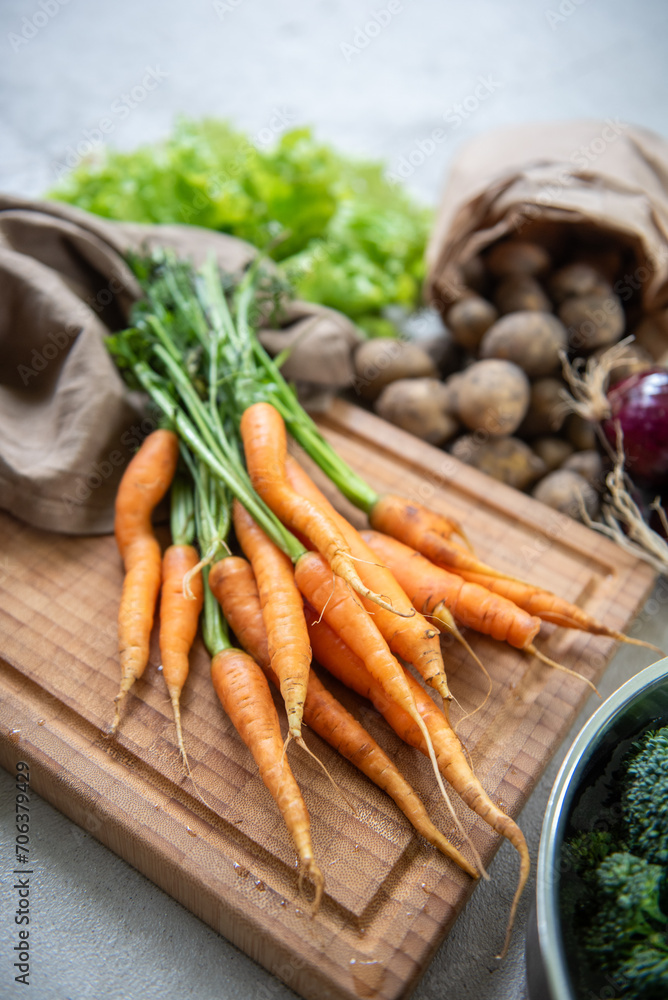 Organic carrots and vegetables fresh from the garden with concrete background. Organic carrots and vegetables fresh from the garden with concrete background.