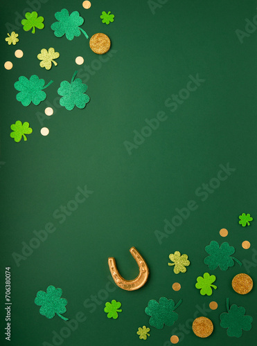 Golden Horseshoe, Gold Coins and Clover Leaves Shamrocks on Green Background for St Patricks Day Concept.