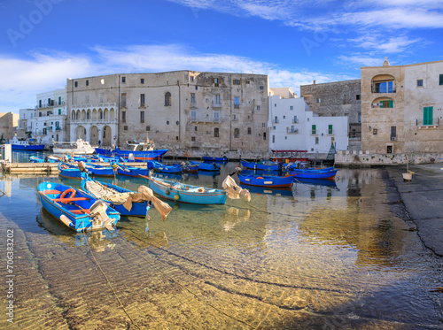 Old port of Monopoli in Apulia, southern Italy: view of the old town with fishing and rowing boats. 