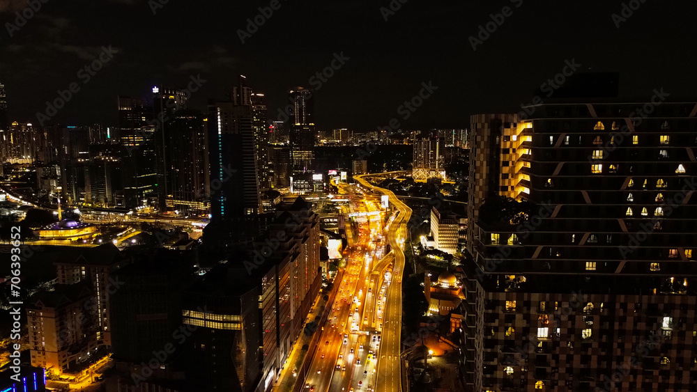 Aerial view of the night city of Kuala Lumpur in Malaysia. Capital city in Southeast Asia. View of the streets in the light of night lights, traffic on the roads at night.