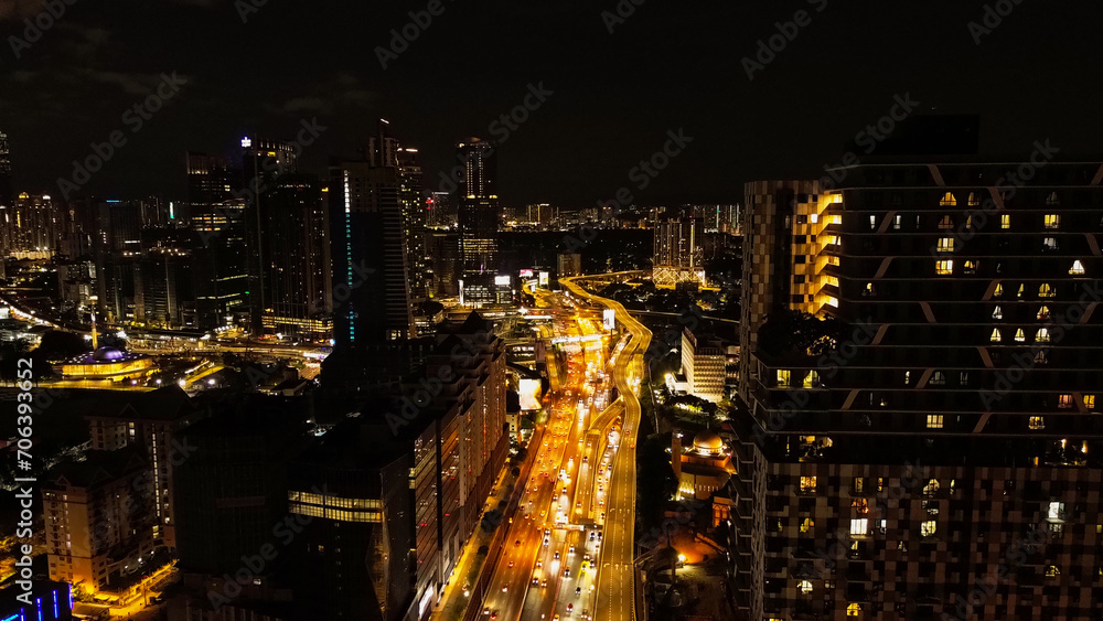 Obraz premium Aerial view of the night city of Kuala Lumpur in Malaysia. Capital city in Southeast Asia. View of the streets in the light of night lights, traffic on the roads at night.