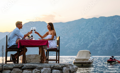 Couple is having a private event dinner on a tropical beach during sunset time