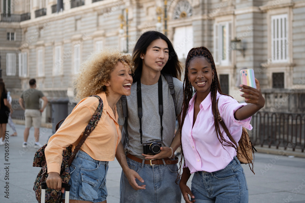 Multiethnic group of tourists friends taking a selfie in Madrid city