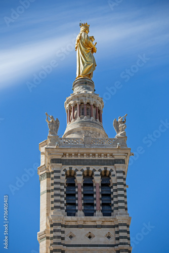 Golden blessed Mary with Jesus child on top of the tower of Cathedral of Notre-Dame de la Garde in Marseille, France