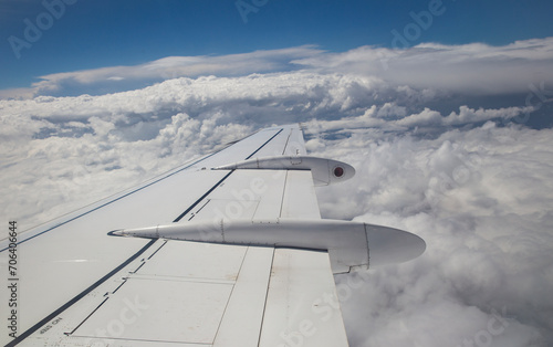 Aerial view by the airplane wing while flying through the clouds