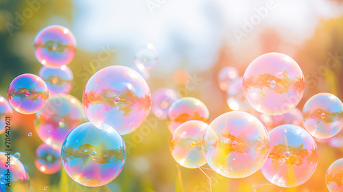 Multiple colorful soap bubbles float amidst a sunlit natural setting, creating a whimsical atmosphere.