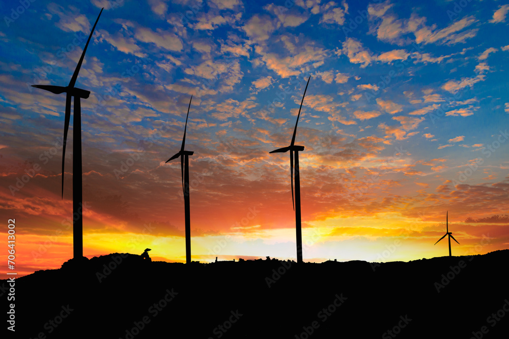Fototapeta premium Silhouette of a wind turbine generating electricity on sky sunset background ,from wind power for environmental,clean energy concept