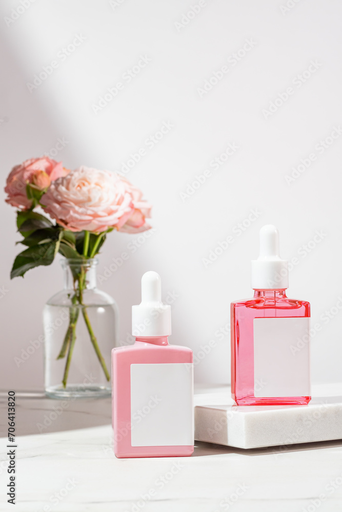 Trendy background with natural cosmetic skincare bottles. Product presentation. Beauty and body care product concept. Beauty oil with rose extract in square glass bottles. Trendy background with natural cosmetic skincare bottles. Product presentation. Beauty and body care product concept. Beauty oil with rose extract in square glass bottles.