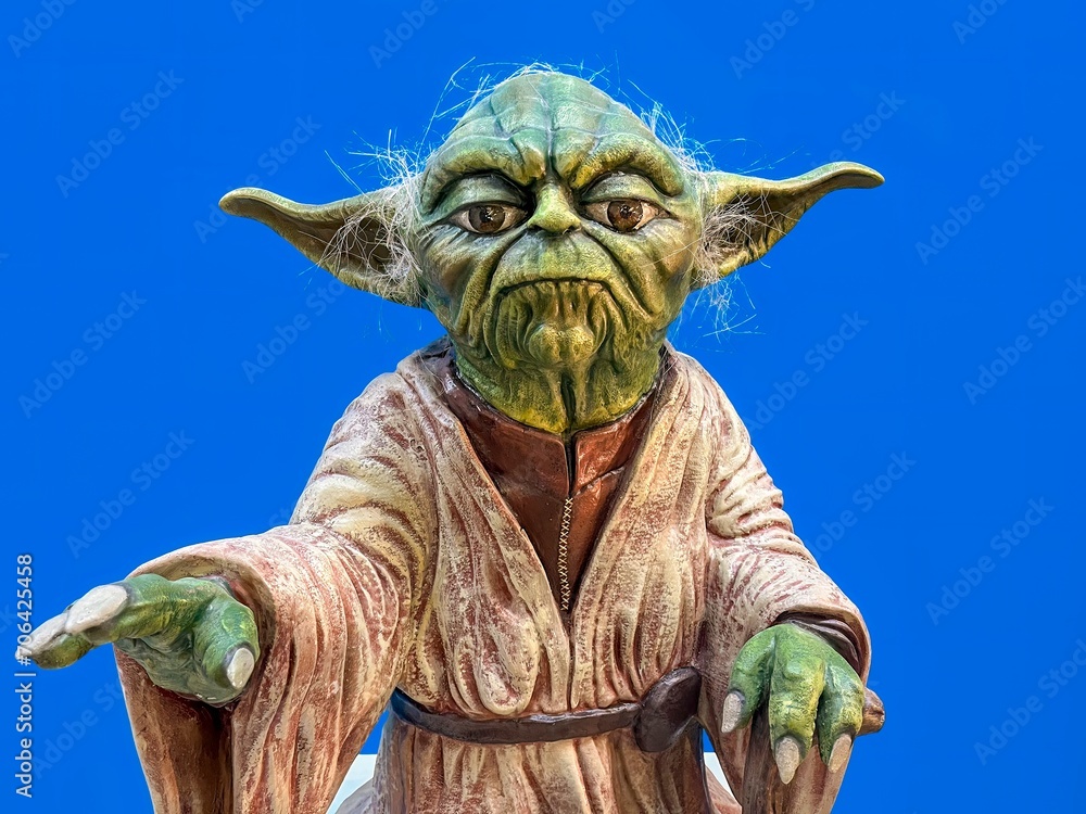 Naklejka premium Madrid, Spain; 01-03-2024: Life-size figure of the iconic character from the Star Wars movie saga Yoda, Grand Master of the Jedi Order