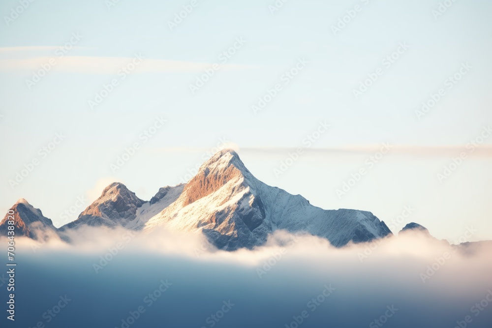 mountain peaks protruding through a heavy blanket of fog