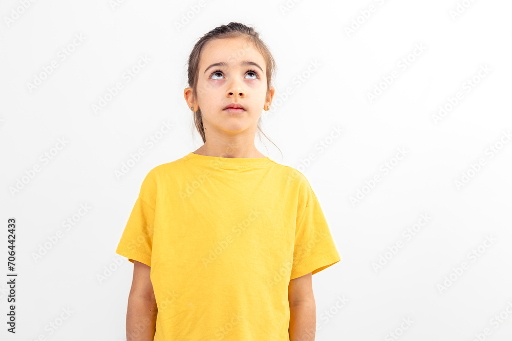 Funny little girl looking up seriously, isolated on white. Funny little girl looking up seriously, isolated on white.