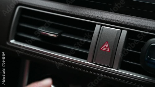Driver touching an emergency light button in car. Use emergency lights when the car breaks down and is unable to move. photo