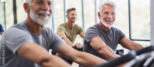 Group of older men staying active at the gym using the rowing machine.